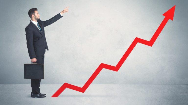 man with briefcase pointing to increasing arrow