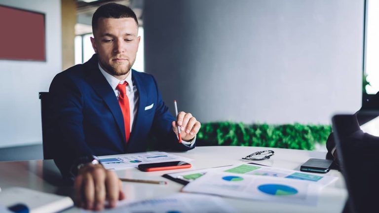 man learning about the 3 golden rules of accounting and looking at charts